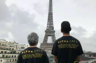 event staff france looking at eiffel tower